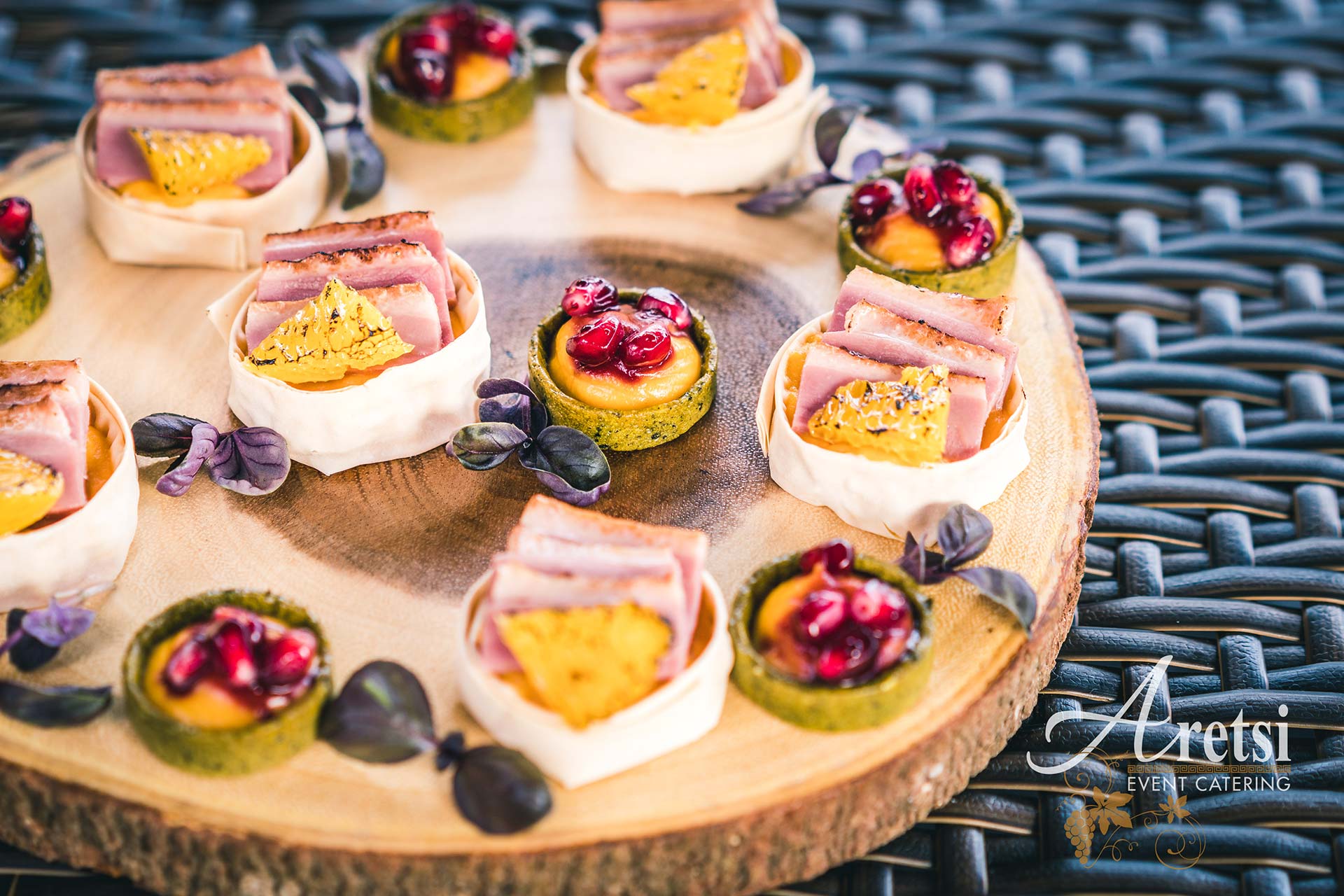 A varied selection of Aretsi canapés on a wooden serving board
