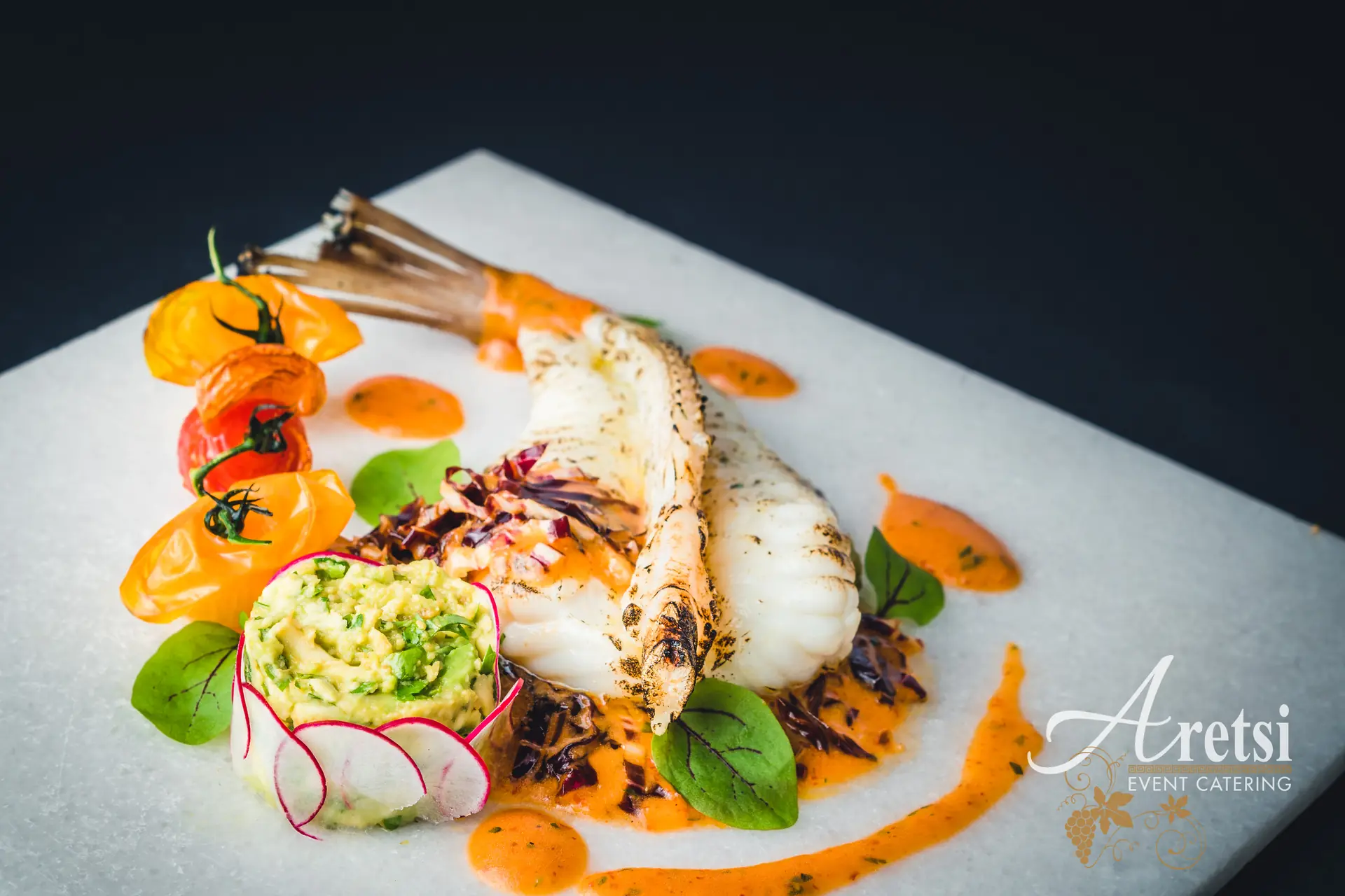 Chargrilled white fish with tomatoes, radish and a pepper sauce, an Aretsi main course