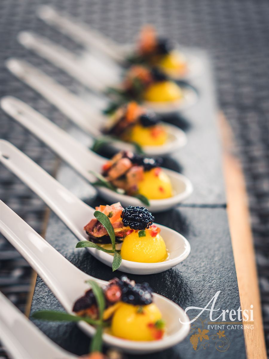 Canapés on porcelain spoons ready to serve