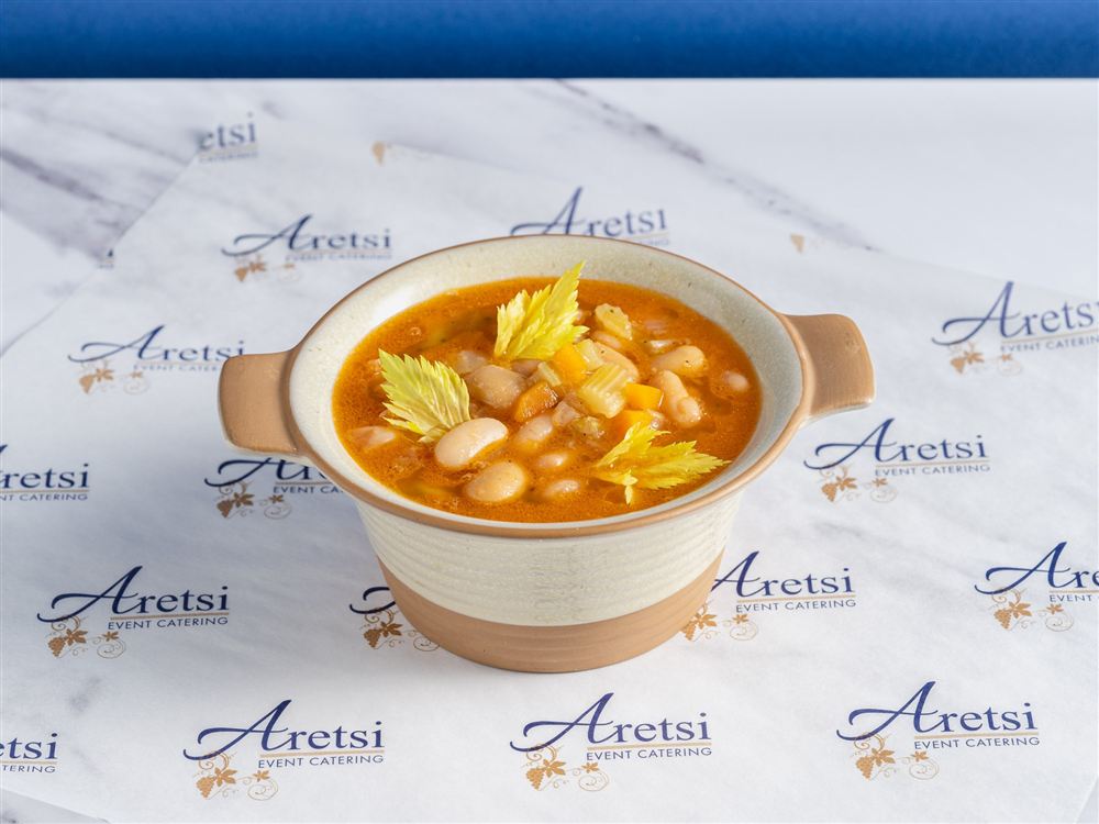 Aretsi fasolada, Greek white bean soup with carrot and celery, in a ceramic bowl