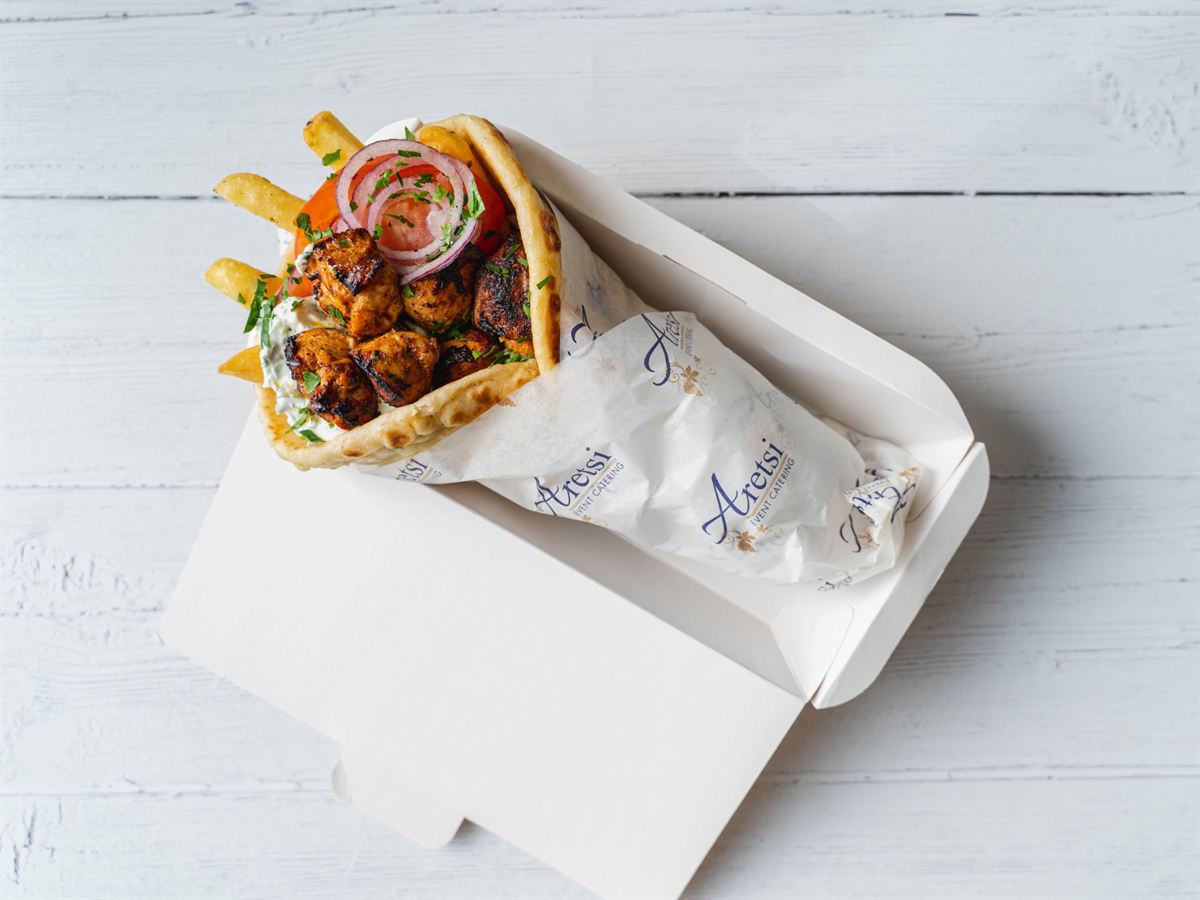 An Aretsi chicken souvlaki pitta with tzatziki, tomato and red onion