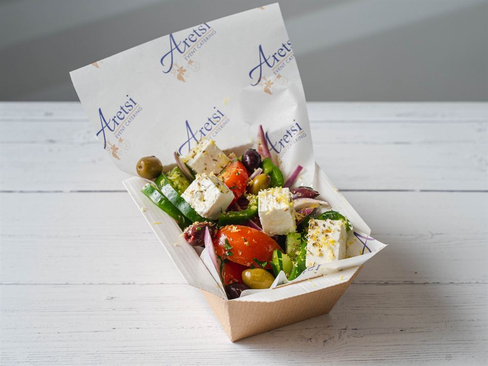 Greek salad with feta, olives and lemon zest in an Aretsi box
